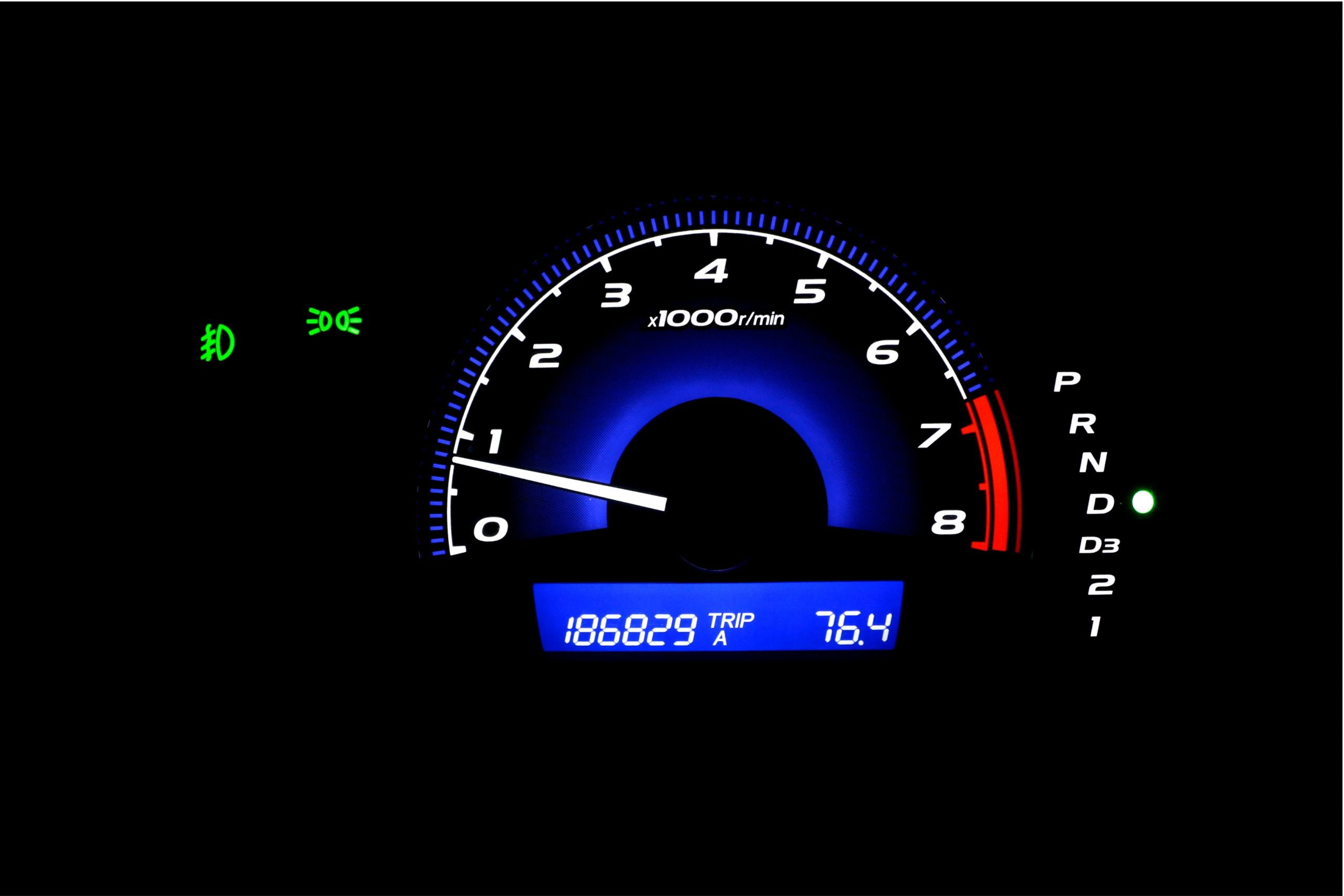 Car dashboard showing MPH and total mileage
