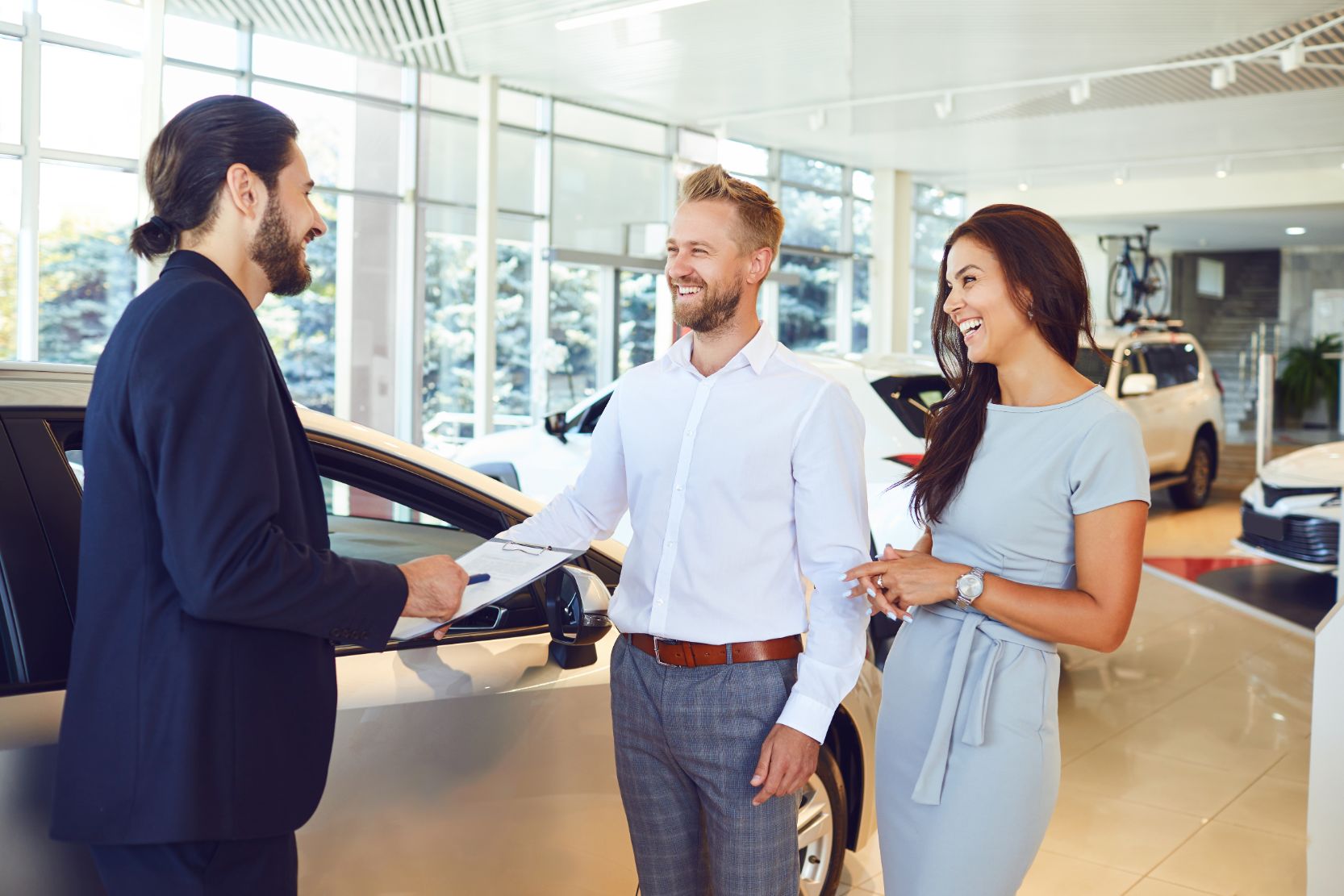 Reliable car salesman agreeing on a deal for new car