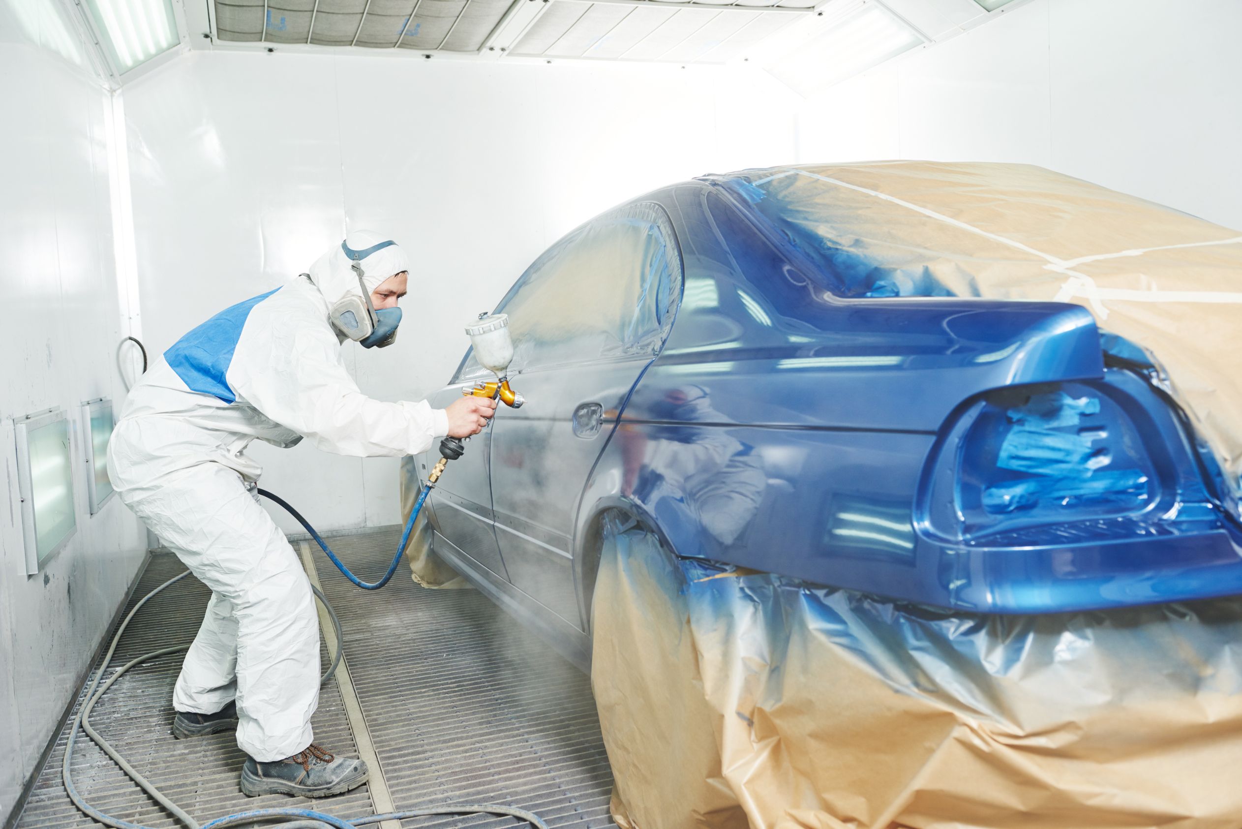 Man spray painting new car