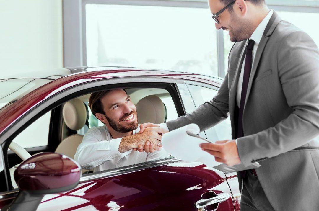 man buying new car using income from selling old car
