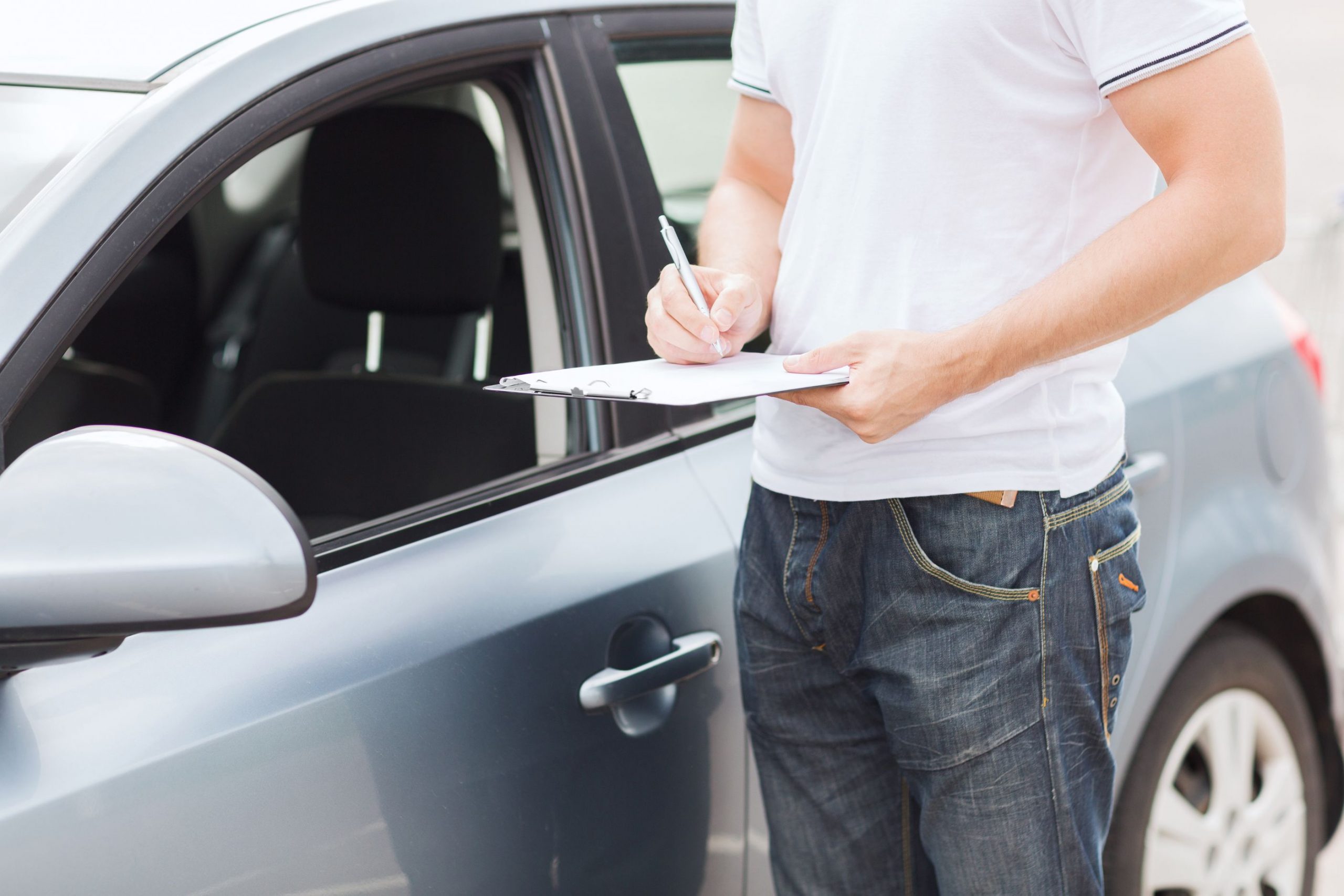 Man checking car documentation prior to purchase