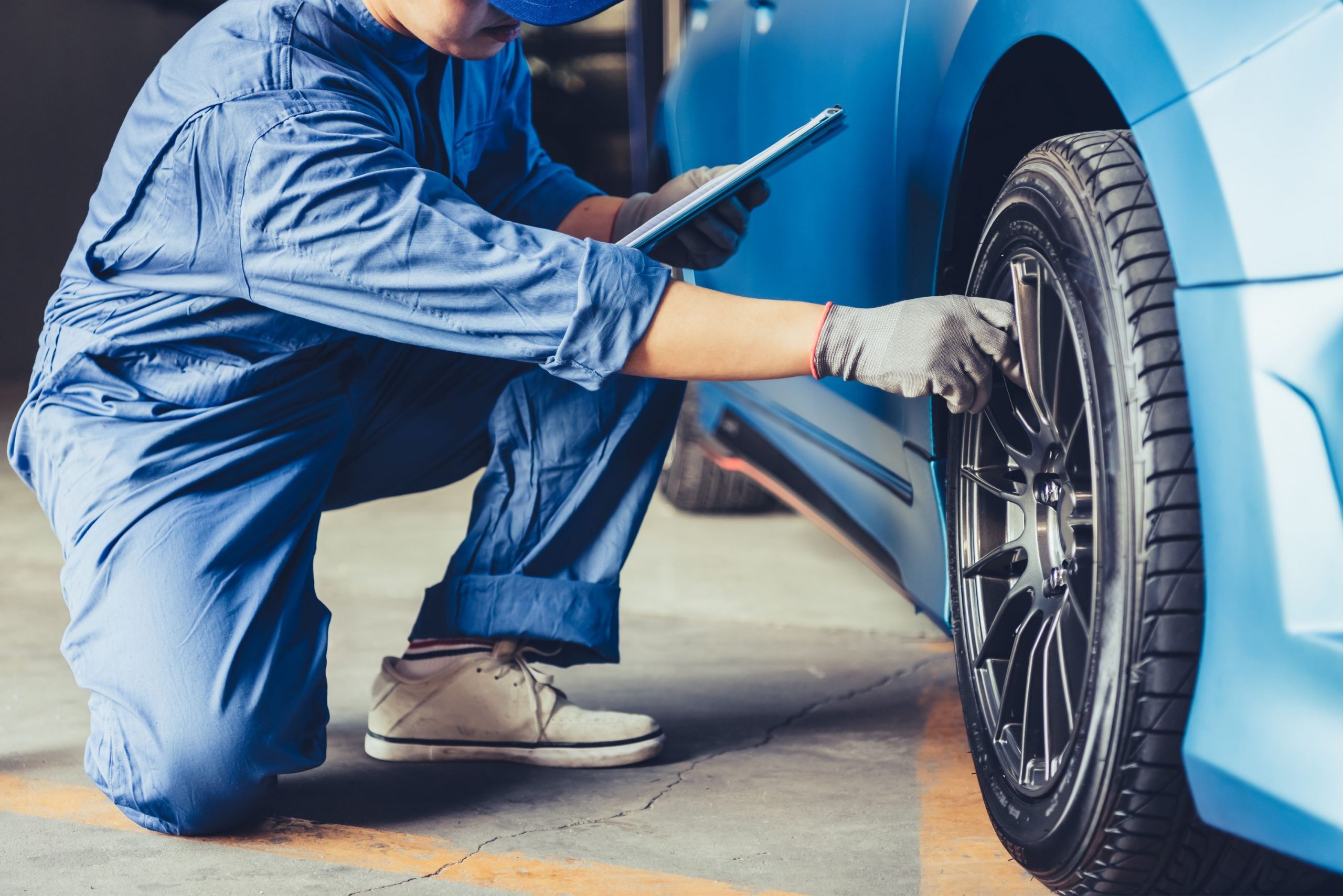 Mechanic checking used car tyres